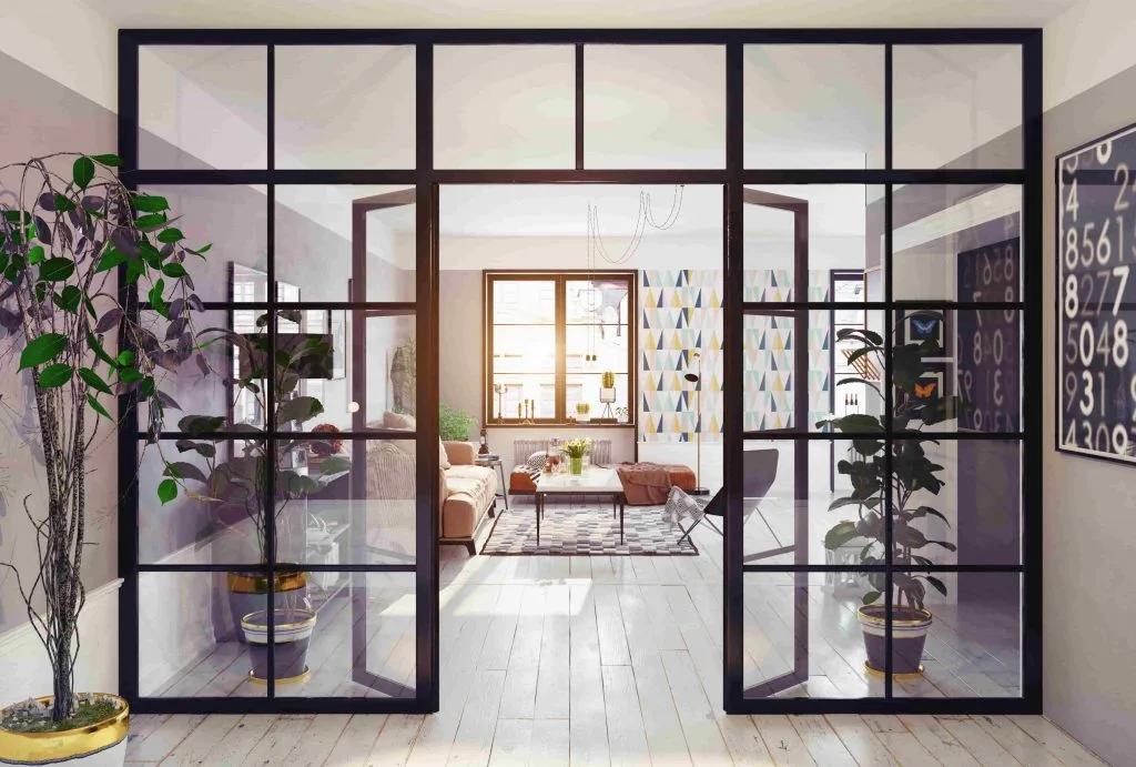 Black-framed glass sliding partition between a living room and a hallway