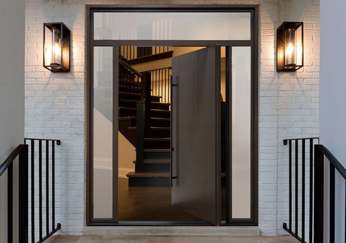 Glazed entrance door with black frame and wall lanterns