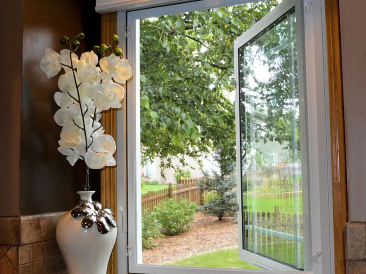 Open casement window with a garden view